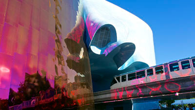 Seattle Monorail Emerging from the EMP Museum by Les Williams is licensed under CC BY-SA 2.0